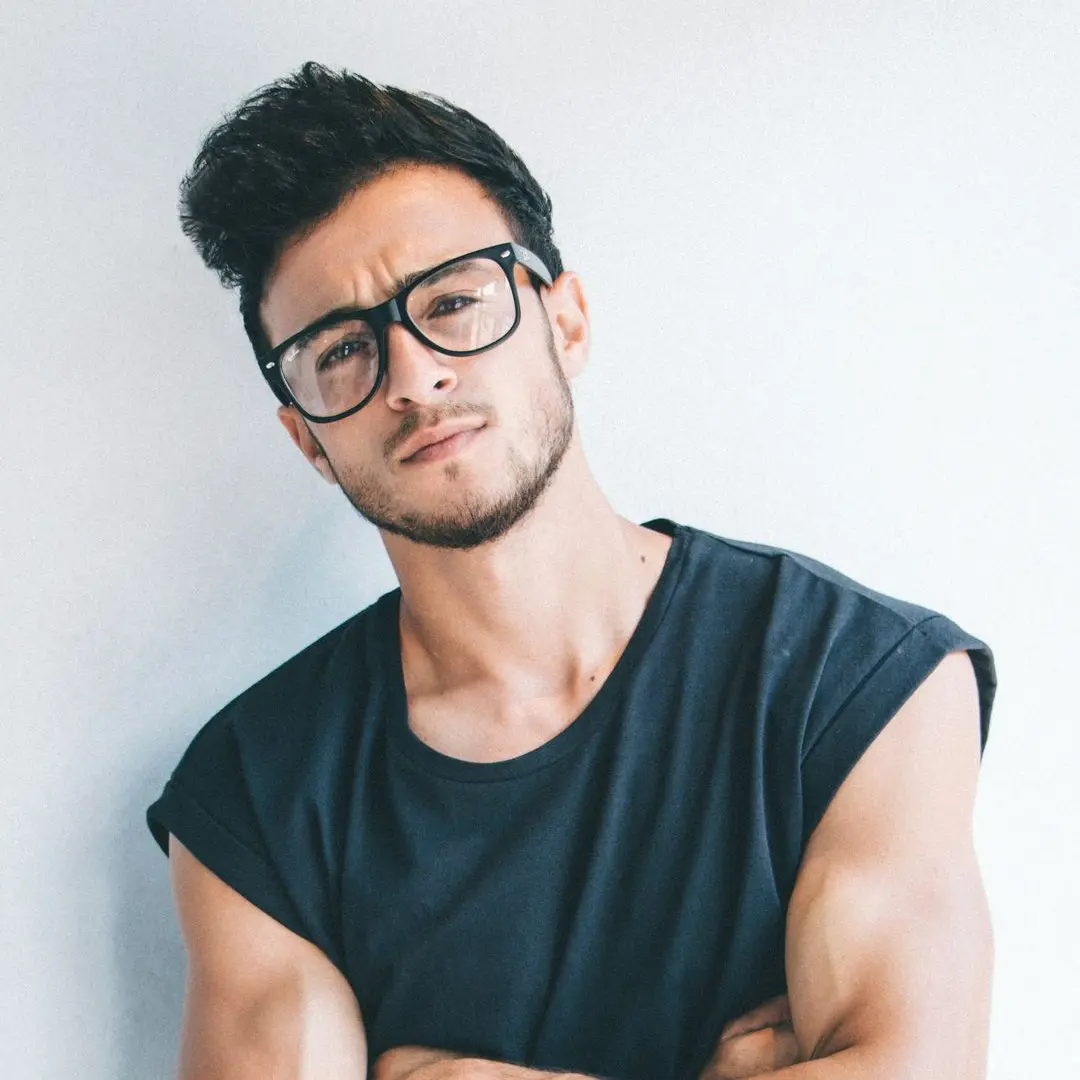 man wearing eyeglasses and sleeveless top